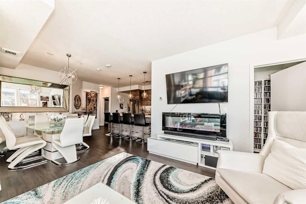 202-122 Mahogany Centre Se, Calgary, AB - Indoor Photo Showing Living Room With Fireplace