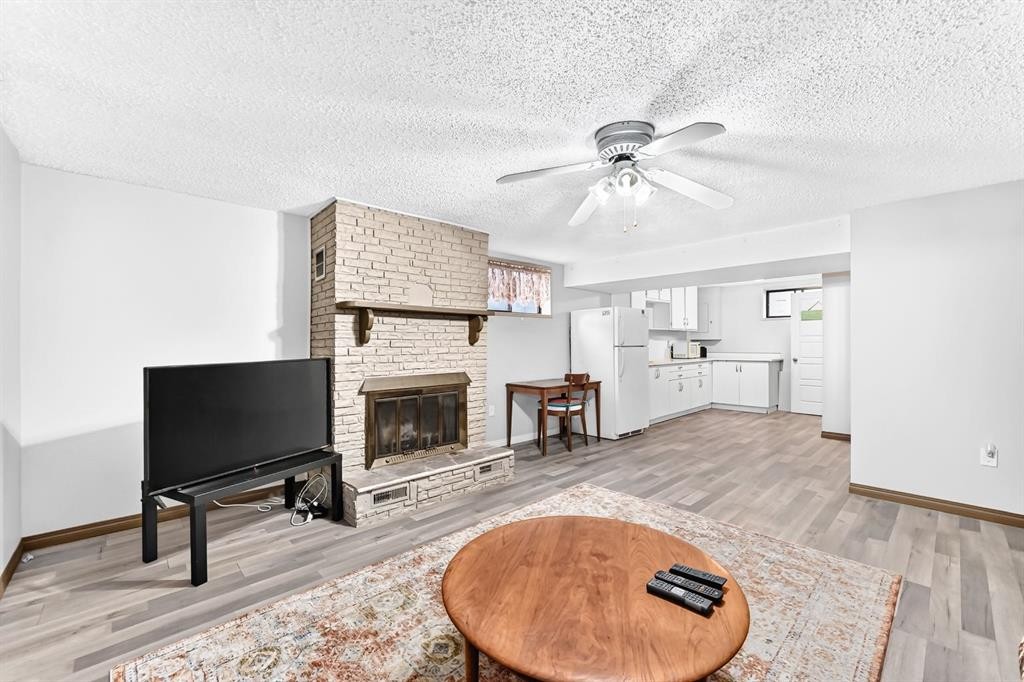 1949 Lytton Crescent Se, Calgary, AB - Indoor Photo Showing Living Room With Fireplace