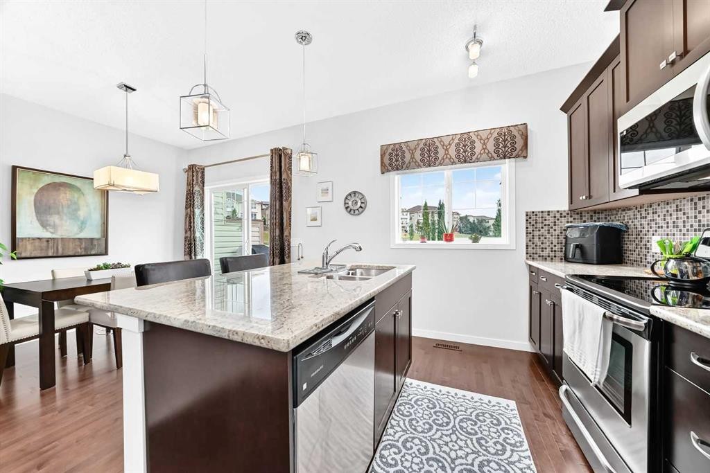 302 Sunset Point, Cochrane, AB - Indoor Photo Showing Kitchen With Upgraded Kitchen