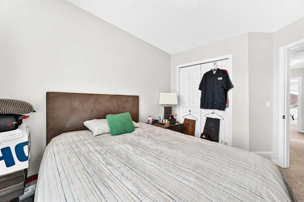 302 Sunset Point, Cochrane, AB - Indoor Photo Showing Bedroom