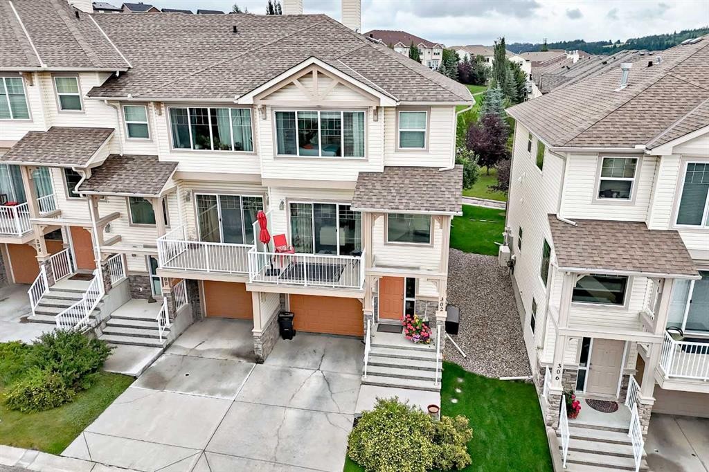 302 Sunset Point, Cochrane, AB - Outdoor With Deck Patio Veranda With Facade