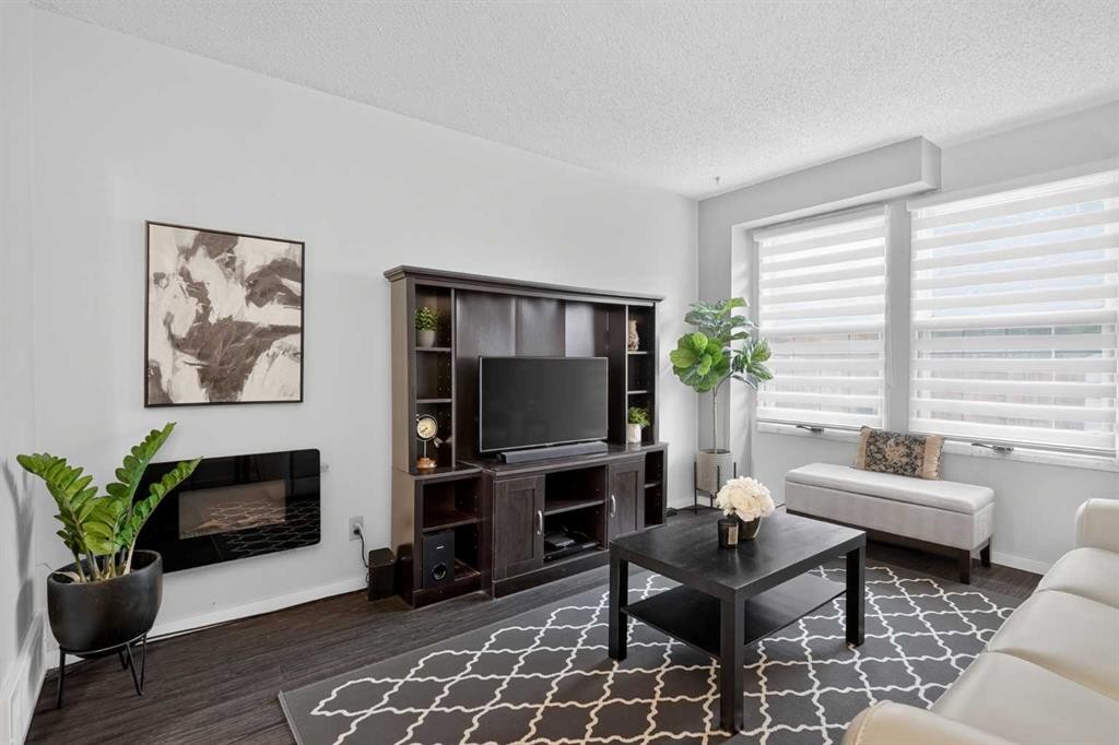 3881 Fonda Way Se, Calgary, AB - Indoor Photo Showing Living Room With Fireplace