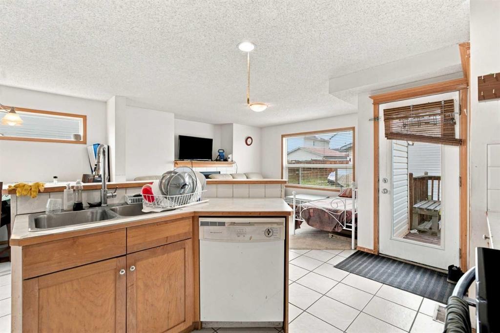 162 Taradale Drive Ne, Calgary, AB - Indoor Photo Showing Kitchen With Double Sink