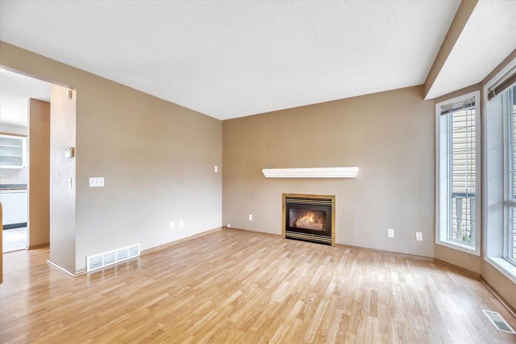 131 Hidden Way Nw, Calgary, AB - Indoor Photo Showing Living Room With Fireplace