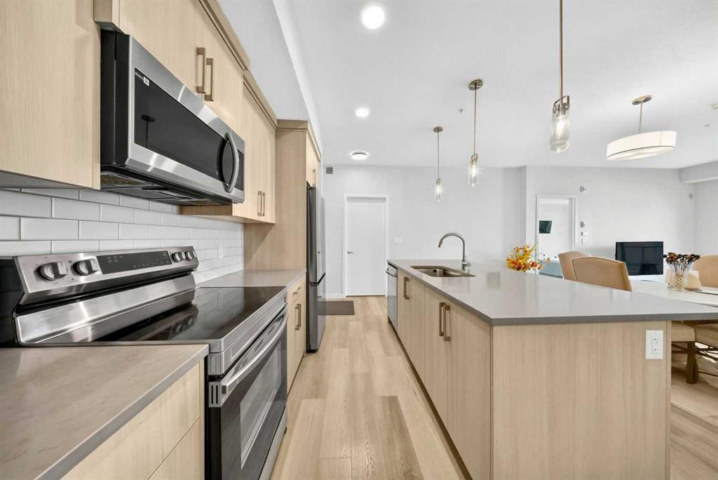 1211-220 Seton Grove Se, Calgary, AB - Indoor Photo Showing Kitchen With Stainless Steel Kitchen With Upgraded Kitchen