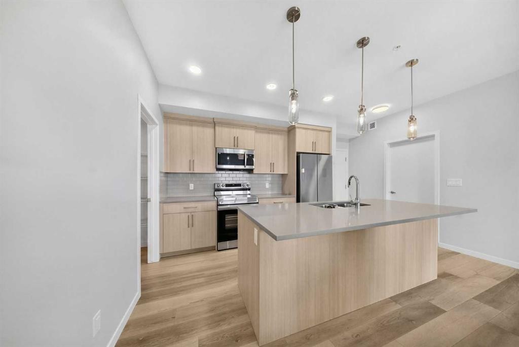 1211-220 Seton Grove Se, Calgary, AB - Indoor Photo Showing Kitchen With Stainless Steel Kitchen With Upgraded Kitchen