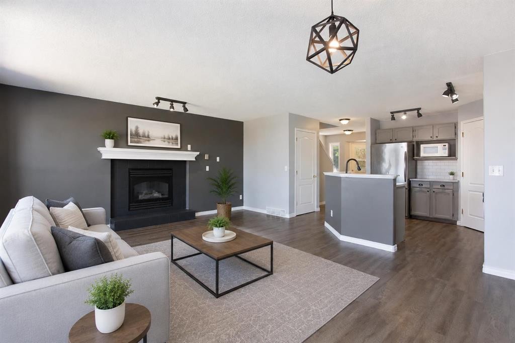 7269 Laguna Way Ne, Calgary, AB - Indoor Photo Showing Living Room With Fireplace