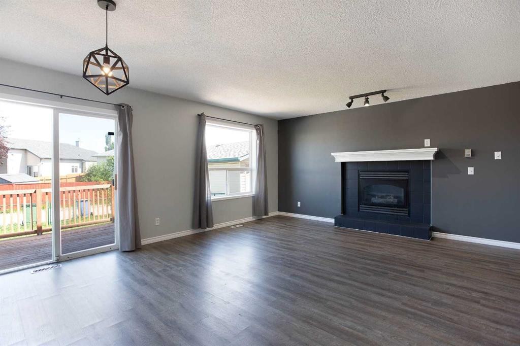 7269 Laguna Way Ne, Calgary, AB - Indoor Photo Showing Living Room With Fireplace