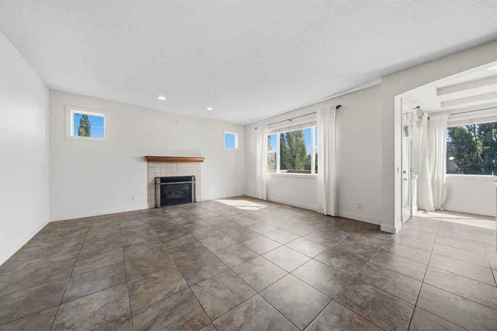 204 Eversyde Mews Sw, Calgary, AB - Indoor Photo Showing Other Room With Fireplace