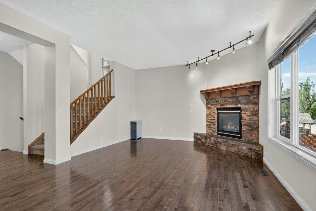 164 Aspenmere Close, Chestermere, AB - Indoor Photo Showing Living Room With Fireplace