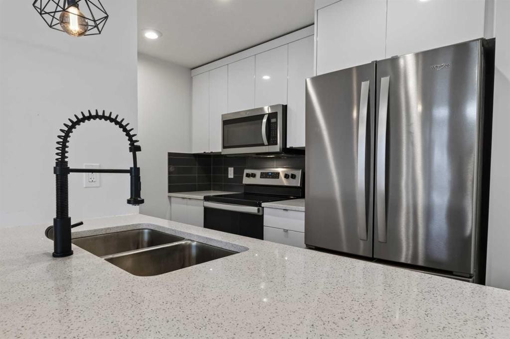 214 Seton Passage Se, Calgary, AB - Indoor Photo Showing Kitchen With Stainless Steel Kitchen With Double Sink With Upgraded Kitchen