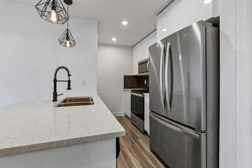 214 Seton Passage Se, Calgary, AB - Indoor Photo Showing Kitchen With Stainless Steel Kitchen With Double Sink
