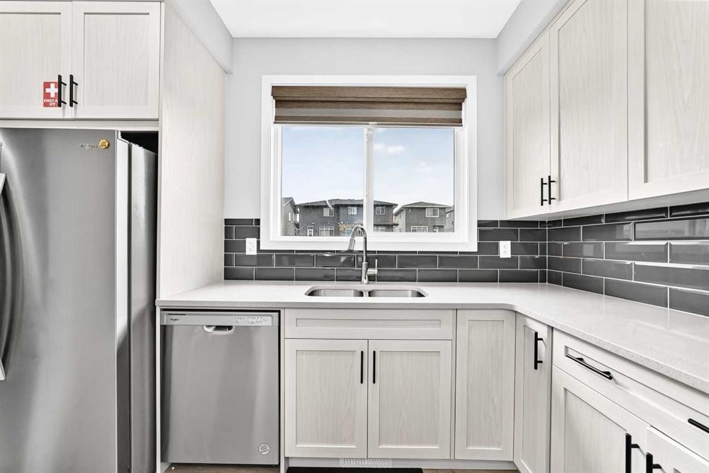 164 Langwell Common Se, Airdrie, AB - Indoor Photo Showing Kitchen With Stainless Steel Kitchen With Double Sink