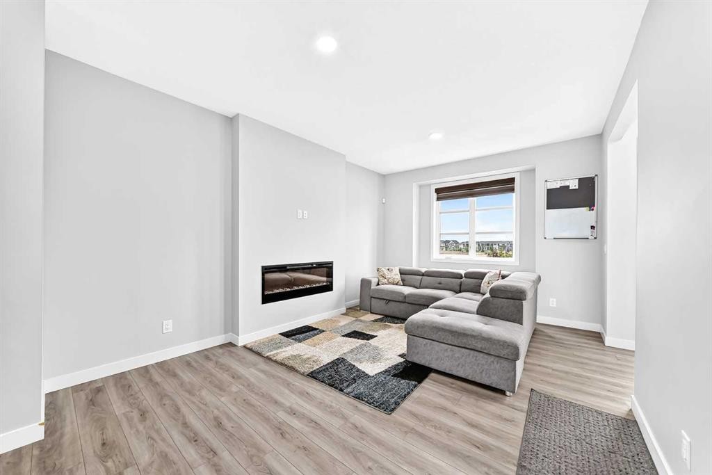 164 Langwell Common Se, Airdrie, AB - Indoor Photo Showing Living Room With Fireplace