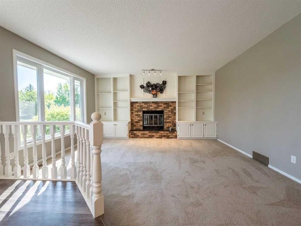 153 Hawkdale Circle Nw, Calgary, AB - Indoor Photo Showing Living Room With Fireplace
