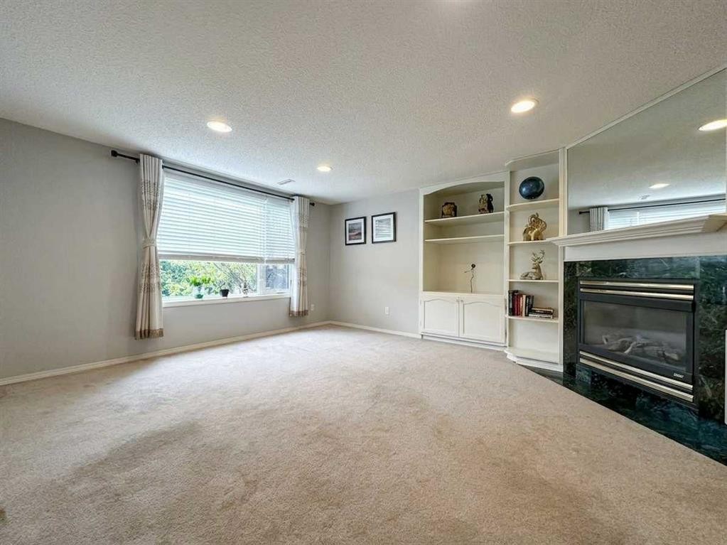 153 Hawkdale Circle Nw, Calgary, AB - Indoor Photo Showing Other Room With Fireplace