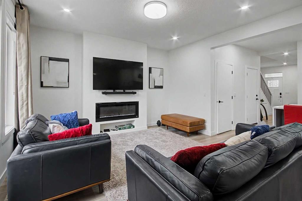67 Copperhead Grove Se, Calgary, AB - Indoor Photo Showing Living Room With Fireplace