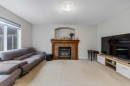 10 Evansmeade Manor Nw, Calgary, AB  - Indoor Photo Showing Living Room With Fireplace 