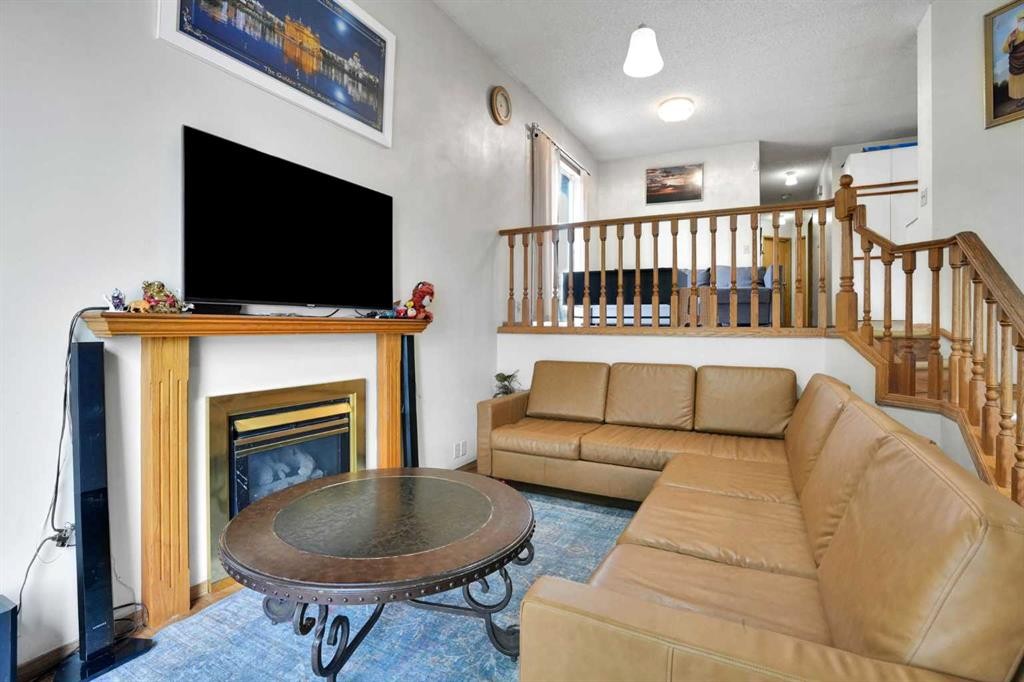 28 Martinridge Road Ne, Calgary, AB - Indoor Photo Showing Living Room With Fireplace