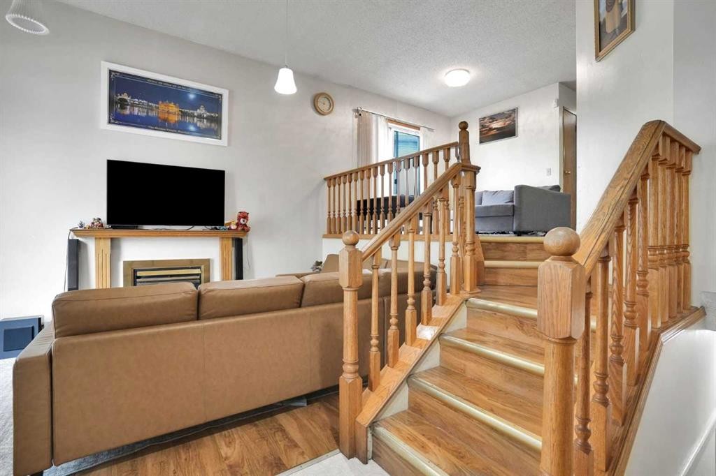 28 Martinridge Road Ne, Calgary, AB - Indoor Photo Showing Other Room With Fireplace