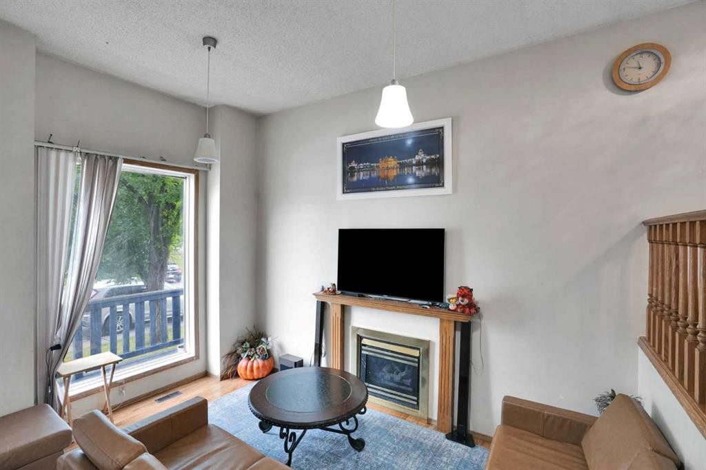 28 Martinridge Road Ne, Calgary, AB - Indoor Photo Showing Living Room With Fireplace