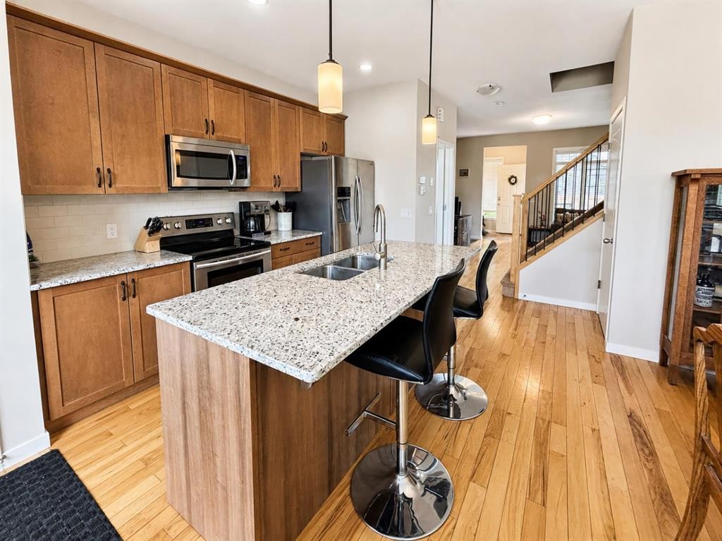 12 Fireside Bend, Cochrane, AB - Indoor Photo Showing Kitchen With Stainless Steel Kitchen With Double Sink