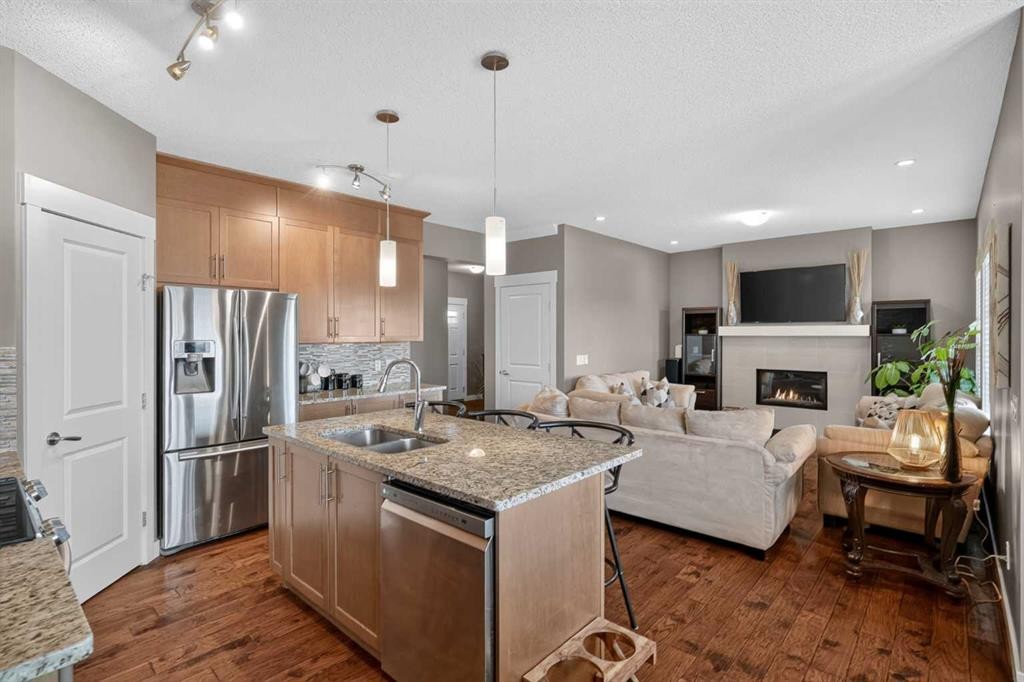 268 Rainbow Falls Green, Chestermere, AB - Indoor Photo Showing Kitchen With Fireplace With Stainless Steel Kitchen With Double Sink With Upgraded Kitchen