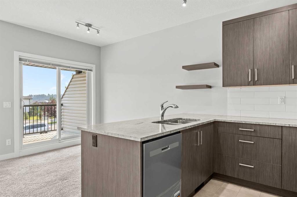 304 Jumping Pound Common, Cochrane, AB - Indoor Photo Showing Kitchen With Double Sink With Upgraded Kitchen