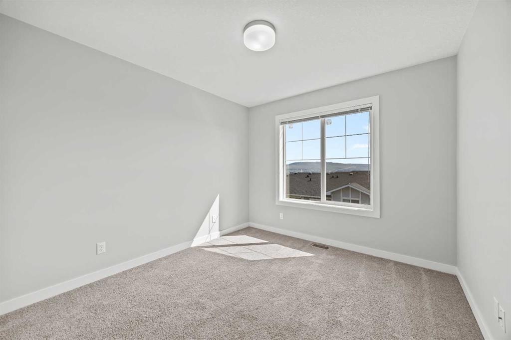 304 Jumping Pound Common, Cochrane, AB - Indoor Photo Showing Other Room