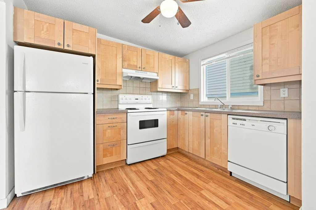 2-7734 Bowness Road Nw, Calgary, AB - Indoor Photo Showing Kitchen With Double Sink
