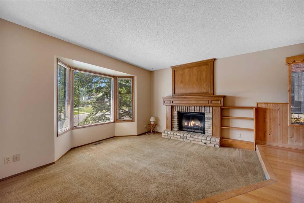 124 Macewan Drive Nw, Calgary, AB - Indoor Photo Showing Living Room With Fireplace