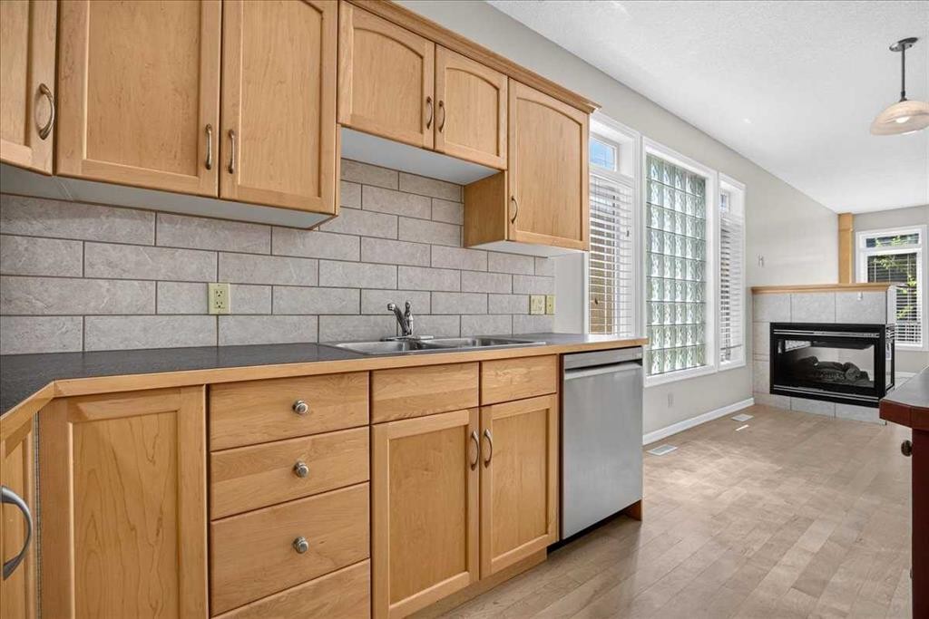 262 21 Avenue Ne, Calgary, AB - Indoor Photo Showing Kitchen With Fireplace With Double Sink