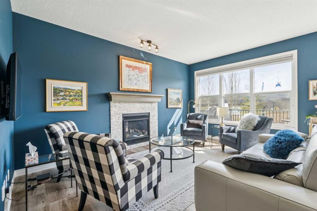 14 Riviera View, Cochrane, AB - Indoor Photo Showing Living Room With Fireplace