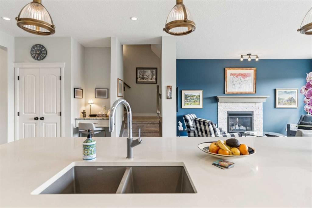 14 Riviera View, Cochrane, AB - Indoor Photo Showing Kitchen With Fireplace With Double Sink