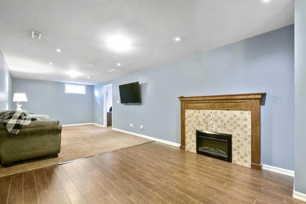 135 Manora Hill Ne, Calgary, AB - Indoor Photo Showing Living Room With Fireplace
