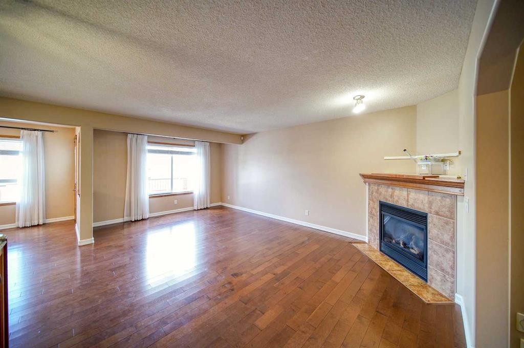 329 Springmere Way, Chestermere, AB - Indoor Photo Showing Living Room With Fireplace