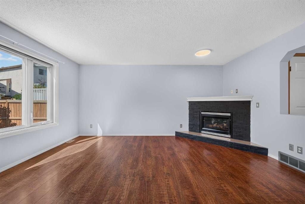 446 Harvest Hills Drive Ne, Calgary, AB - Indoor Photo Showing Living Room With Fireplace