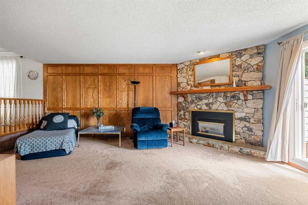 84 Deermoss Crescent Se, Calgary, AB - Indoor Photo Showing Living Room With Fireplace