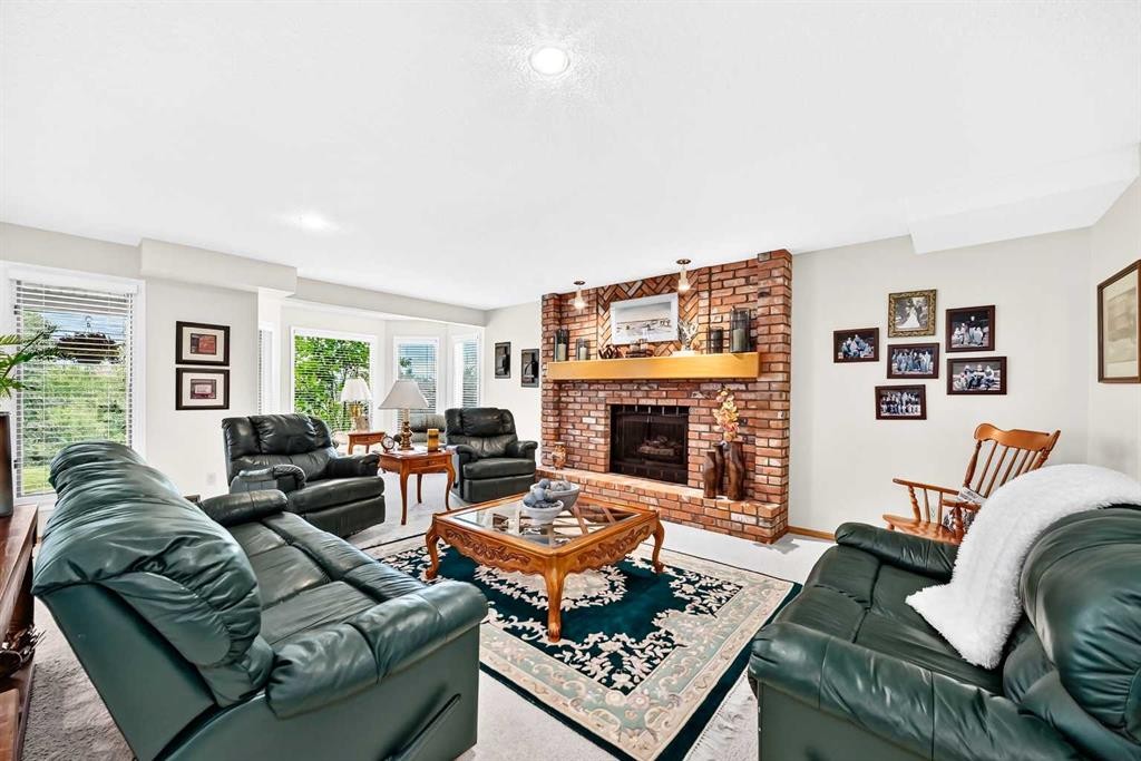 36 Sunset Way, Priddis Greens, AB - Indoor Photo Showing Living Room With Fireplace