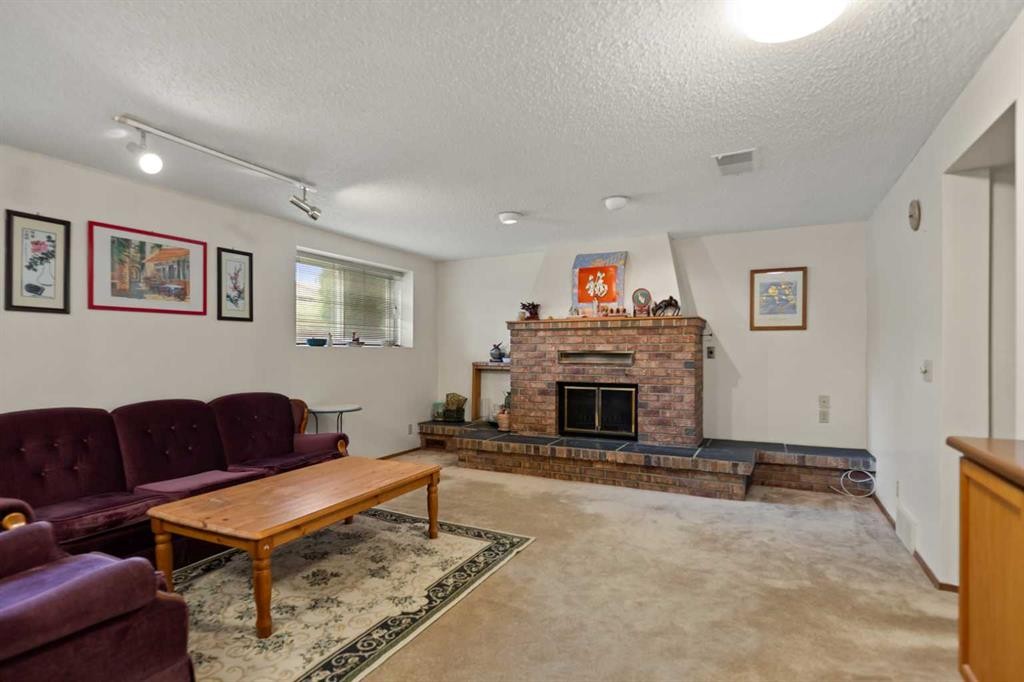 224 Berwick Way Nw, Calgary, AB - Indoor Photo Showing Living Room With Fireplace