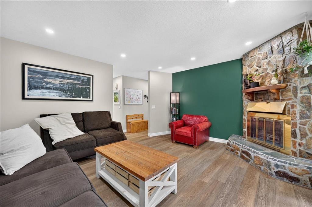 57 Beacham Way Nw, Calgary, AB - Indoor Photo Showing Living Room With Fireplace