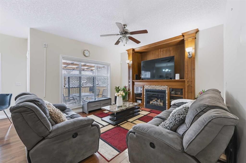 8245 Saddlebrook Drive Ne, Calgary, AB - Indoor Photo Showing Living Room With Fireplace