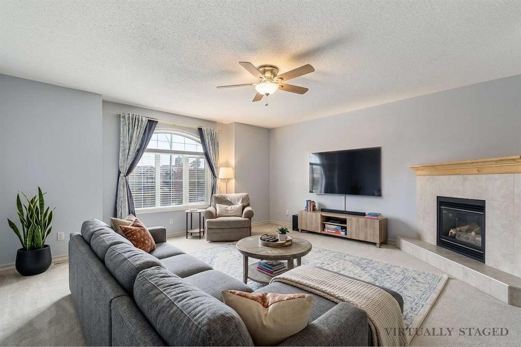 258 West Ranch Place Sw, Calgary, AB - Indoor Photo Showing Living Room With Fireplace