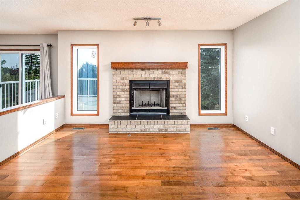 131 Edgebrook Close Nw, Calgary, AB - Indoor Photo Showing Living Room With Fireplace