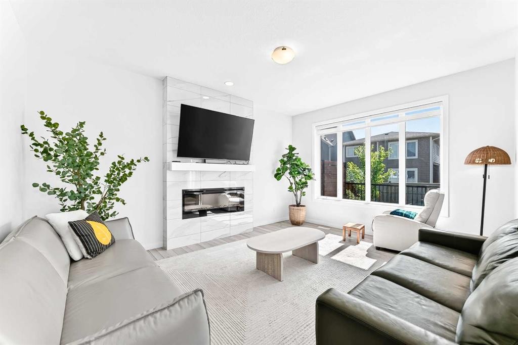 105 Magnolia Manor Se, Calgary, AB - Indoor Photo Showing Living Room With Fireplace