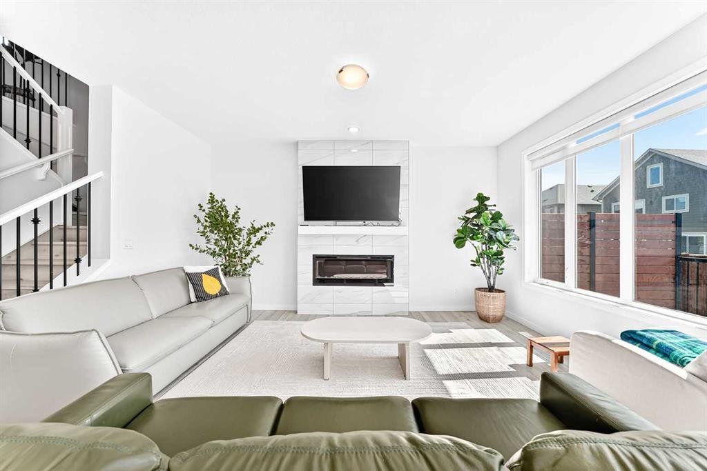 105 Magnolia Manor Se, Calgary, AB - Indoor Photo Showing Living Room With Fireplace