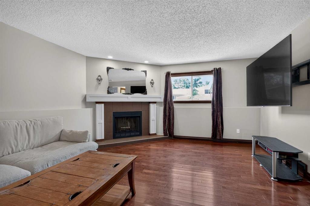 196 Suncrest Way Se, Calgary, AB - Indoor Photo Showing Living Room With Fireplace