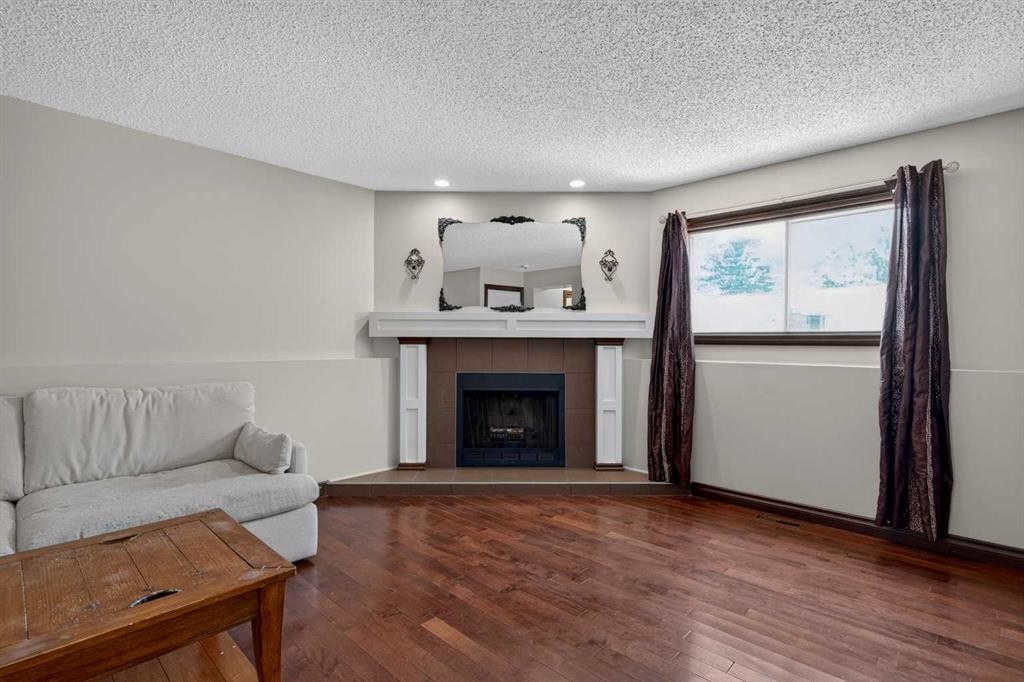 196 Suncrest Way Se, Calgary, AB - Indoor Photo Showing Living Room With Fireplace