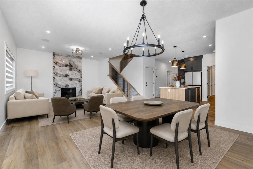 124 Heritage Boulevard, Cochrane, AB - Indoor Photo Showing Dining Room With Fireplace