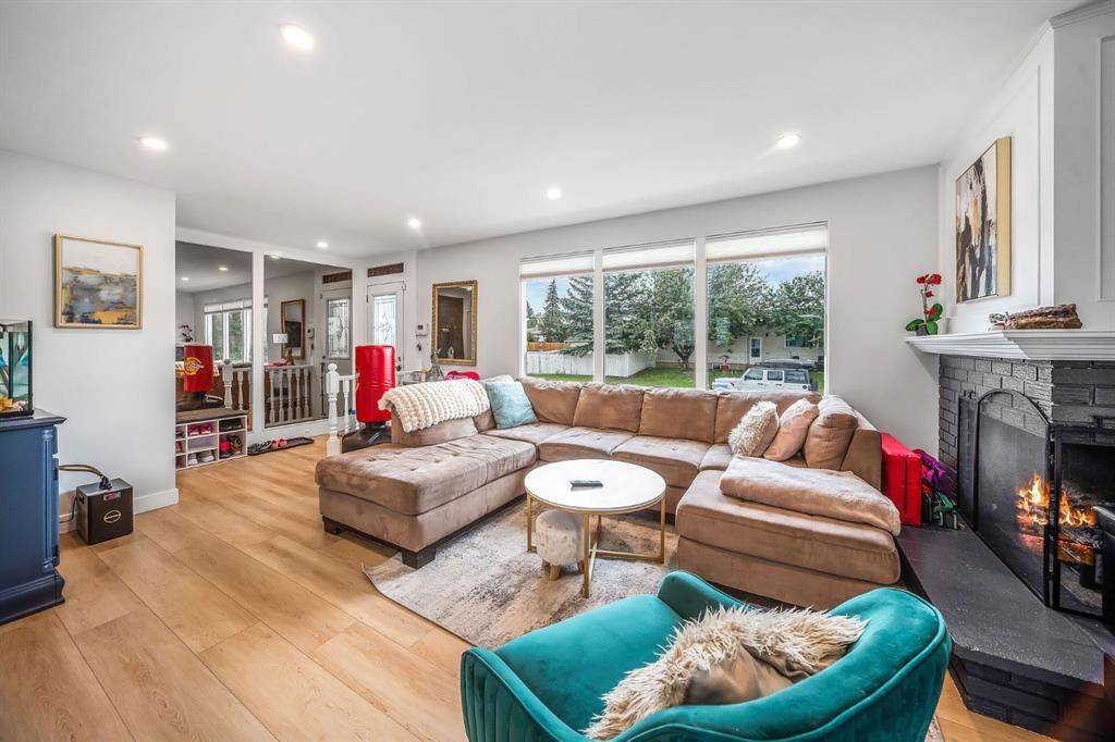 703 Millar Road Ne, Calgary, AB - Indoor Photo Showing Living Room With Fireplace